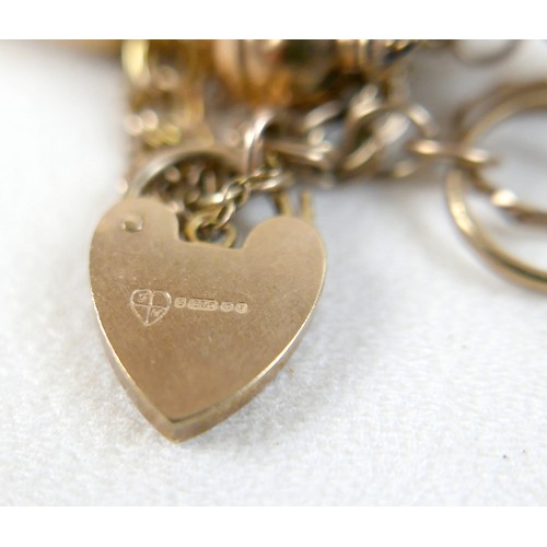 174 - A 9ct yellow gold charm bracelet with eight charms, 25.7g.