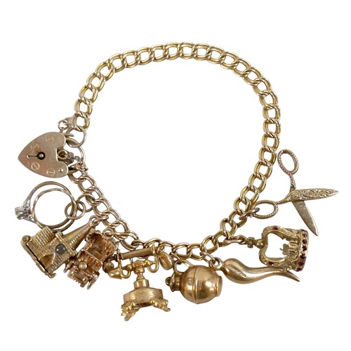 174 - A 9ct yellow gold charm bracelet with eight charms, 25.7g.