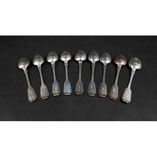 225 - A matched set of nine Victorian silver table spoons, Fiddle pattern, terminal engraved with an initi... 