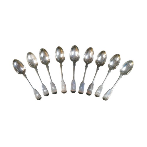225 - A matched set of nine Victorian silver table spoons, Fiddle pattern, terminal engraved with an initi... 