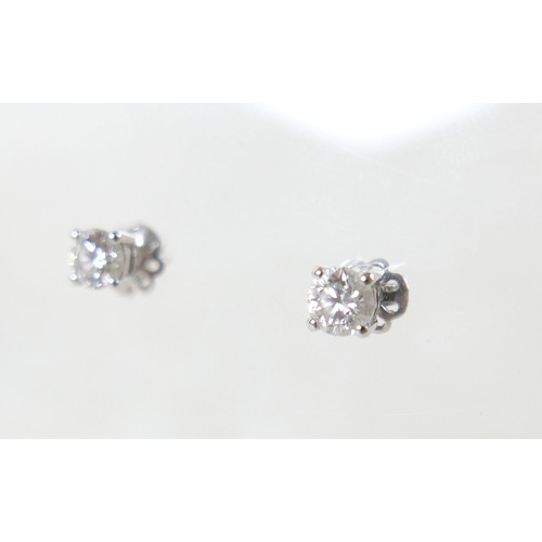 177 - A pair of diamond solitaire stud earrings, set in 18ct white gold, each stone approx. 0.7ct, SI2, co... 