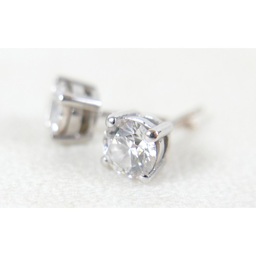177 - A pair of diamond solitaire stud earrings, set in 18ct white gold, each stone approx. 0.7ct, SI2, co... 