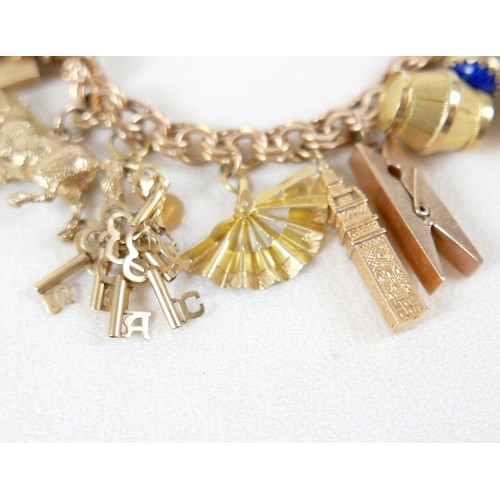176 - A 9ct gold charm bracelet with assorted 9ct gold, 18ct and gilt metal charms, including 9ct Melton M... 