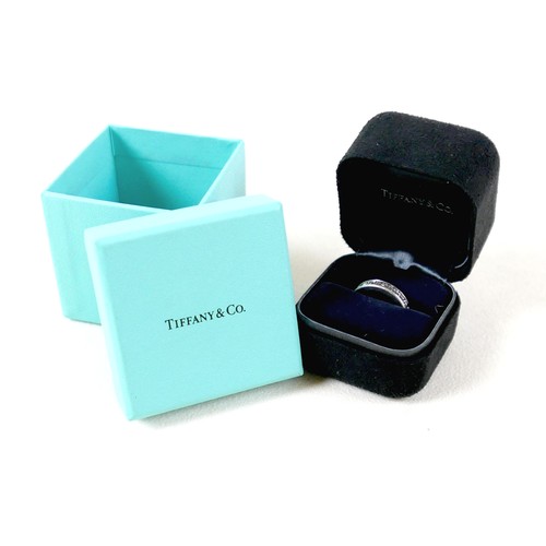 182 - A Tiffany & Co diamond and platinum full eternity ring, with thirty one channel set baguette cut dia... 