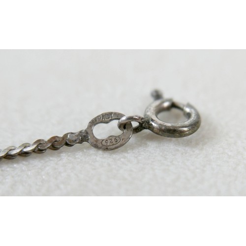87 - A small group of silver and white metal jewellery, including a charm bracelet, two rings, sports med... 