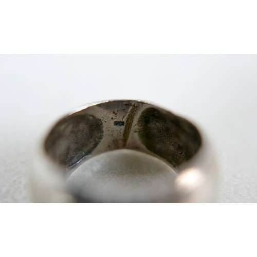 87 - A small group of silver and white metal jewellery, including a charm bracelet, two rings, sports med... 