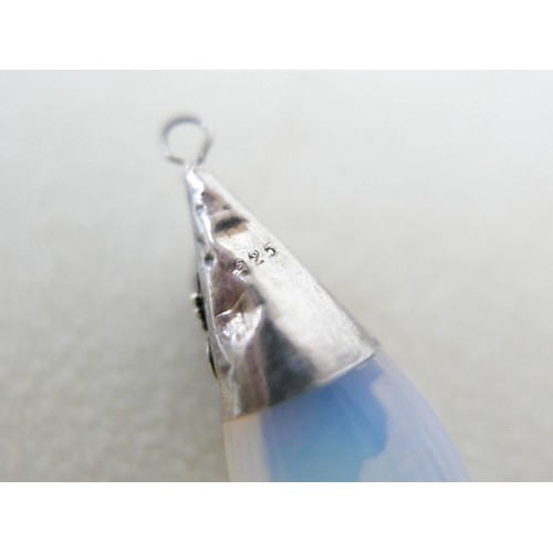 87 - A small group of silver and white metal jewellery, including a charm bracelet, two rings, sports med... 