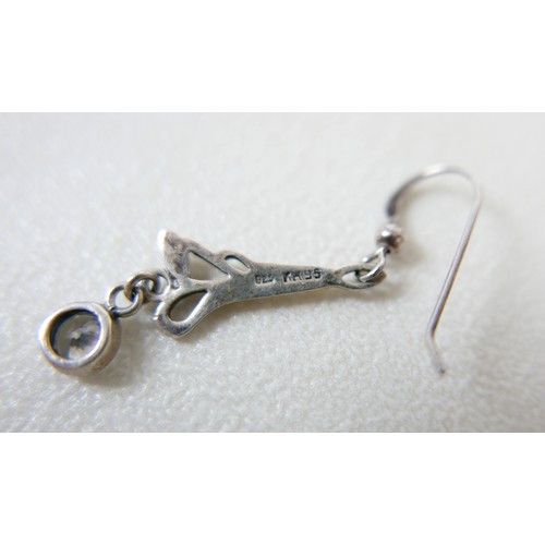 87 - A small group of silver and white metal jewellery, including a charm bracelet, two rings, sports med... 