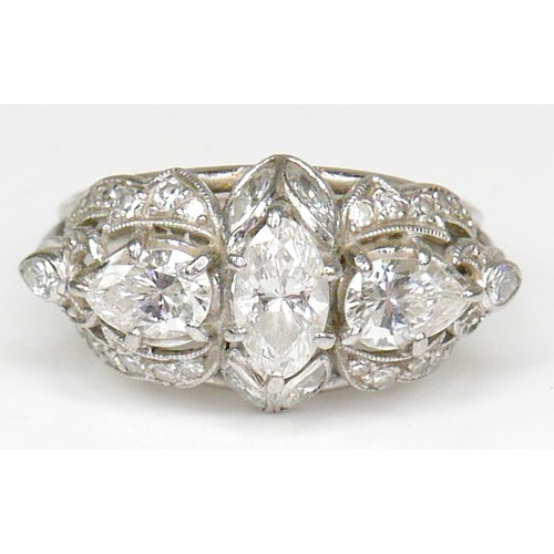 174 - A diamond set fancy cluster ring, centering on a marquise cut diamond, measuring 7.1mm by 4.2mm, dep... 