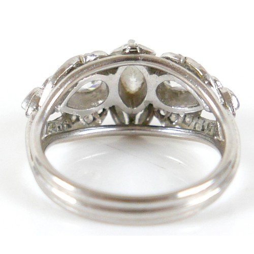 174 - A diamond set fancy cluster ring, centering on a marquise cut diamond, measuring 7.1mm by 4.2mm, dep... 