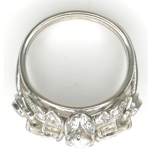 174 - A diamond set fancy cluster ring, centering on a marquise cut diamond, measuring 7.1mm by 4.2mm, dep... 