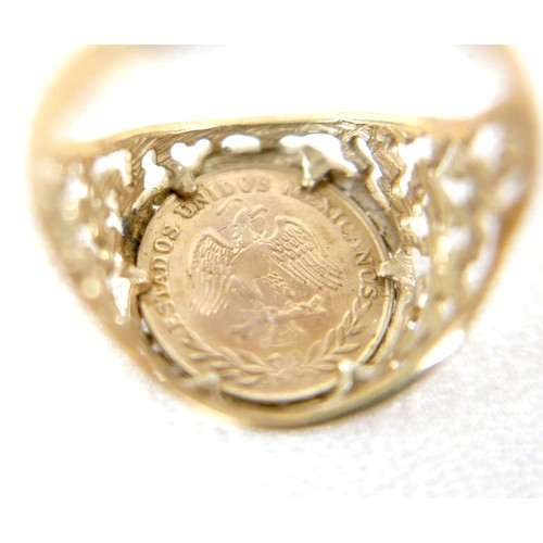 24 - A 9ct gold ring inset with yellow metal Mexican style coin, size Q, 3g.