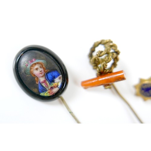 26 - A collection of four stick pins including a portrait pin.(4)