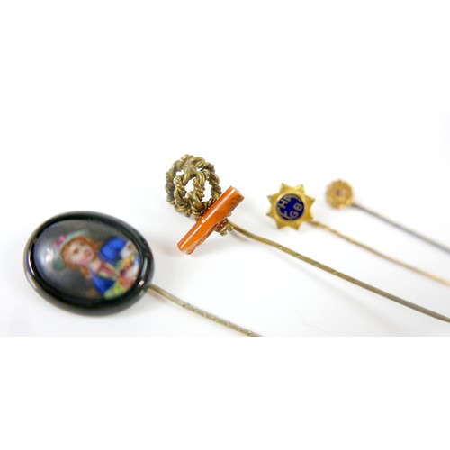 26 - A collection of four stick pins including a portrait pin.(4)