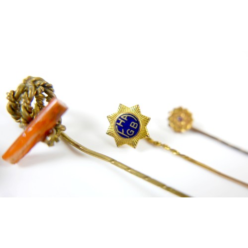 26 - A collection of four stick pins including a portrait pin.(4)