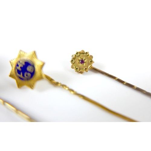26 - A collection of four stick pins including a portrait pin.(4)