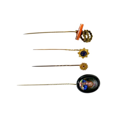 26 - A collection of four stick pins including a portrait pin.(4)
