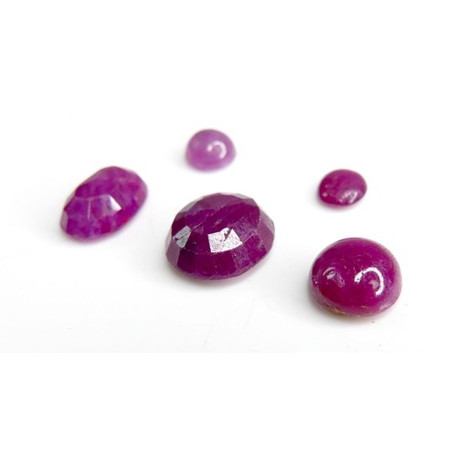30 - Five loose rubies, including three oval cut stones, largest 9mm by 10mm, together with one round cut... 