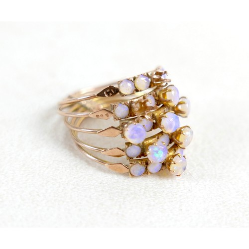 35 - A 14k gold and opal ring, designed as five rings attached at the base, total weight 5.62g (lacking t... 