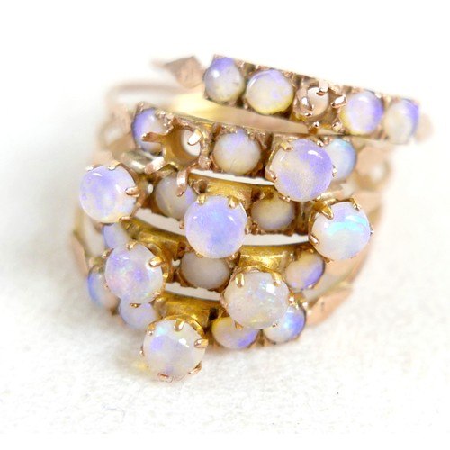 35 - A 14k gold and opal ring, designed as five rings attached at the base, total weight 5.62g (lacking t... 
