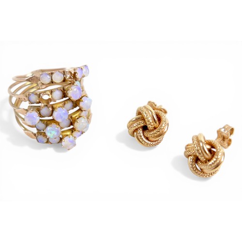 35 - A 14k gold and opal ring, designed as five rings attached at the base, total weight 5.62g (lacking t... 