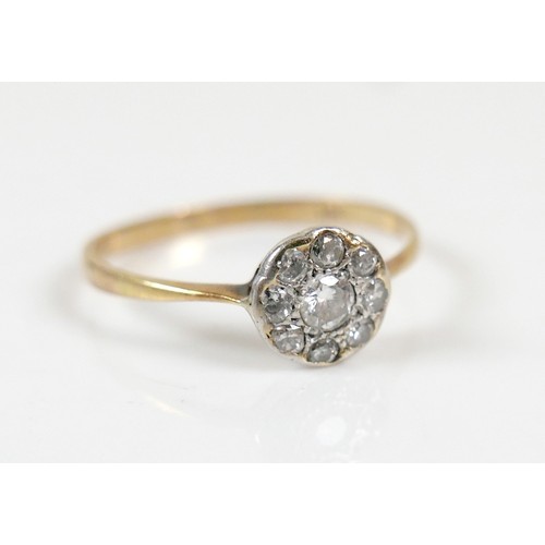 41 - An Edwardian 18ct yellow gold ring, set with nine diamonds in the form of a flowerhead, central ston... 