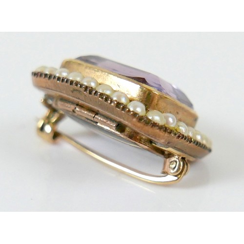 44 - A yellow metal mourning brooch with a central amethyst surrounded by seed pearls, 23 by 20 by 12mm, ... 