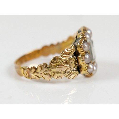 46 - A 19th century yellow metal and pearl mourning ring surface tests to approximately 18ct, head size 1... 