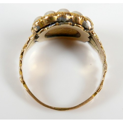 46 - A 19th century yellow metal and pearl mourning ring surface tests to approximately 18ct, head size 1... 
