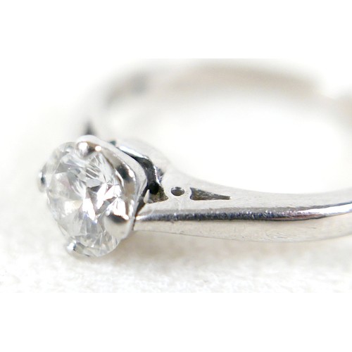 20 - A platinum and diamond solitaire ring, the brilliant cut stone approx 0.6ct, size K, 4.3g.