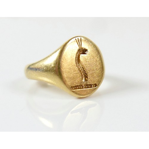 19 - An 18ct yellow gold signet ring with crowned dragon motto size J, 10.5g.