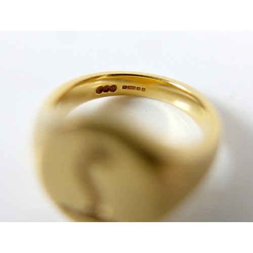 19 - An 18ct yellow gold signet ring with crowned dragon motto size J, 10.5g.