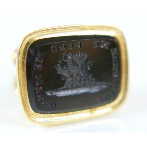 15 - A collection of five yellow metal fobs a serpent ring, four are intaglio, largest fob 16 by 14 by 24... 