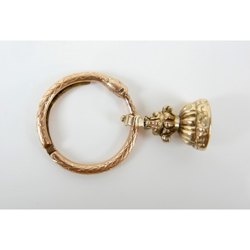 15 - A collection of five yellow metal fobs a serpent ring, four are intaglio, largest fob 16 by 14 by 24... 