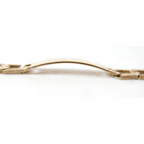 13 - A 9ct gold identity bracelet, with flat curb link, bark effect chain, blank identity tag, 20.5cm lon... 