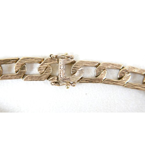 13 - A 9ct gold identity bracelet, with flat curb link, bark effect chain, blank identity tag, 20.5cm lon... 
