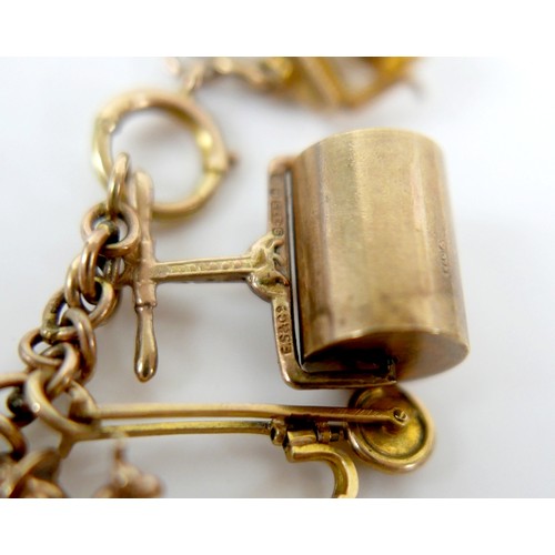 11 - A 9ct yellow gold charm bracelet with twenty charms, 35.3g.