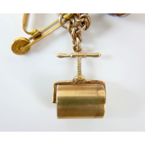 11 - A 9ct yellow gold charm bracelet with twenty charms, 35.3g.