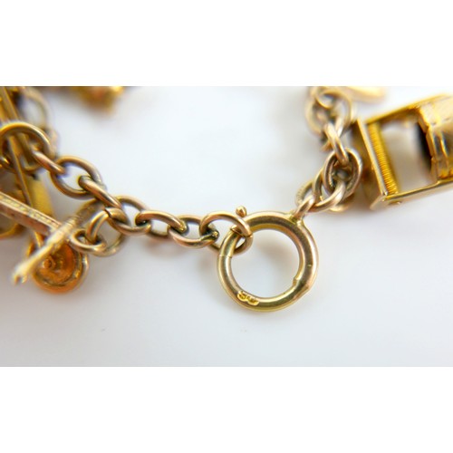 11 - A 9ct yellow gold charm bracelet with twenty charms, 35.3g.