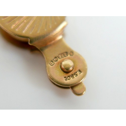 11 - A 9ct yellow gold charm bracelet with twenty charms, 35.3g.