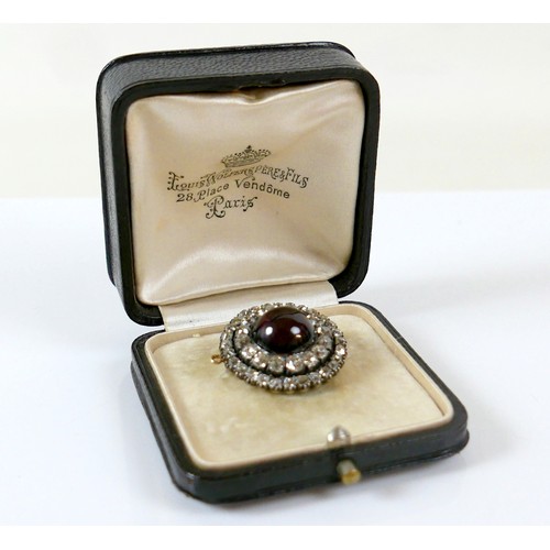 9 - A 19th century yellow metal diamond brooch with a central red paste cabochon 13mm diameter surrounde... 