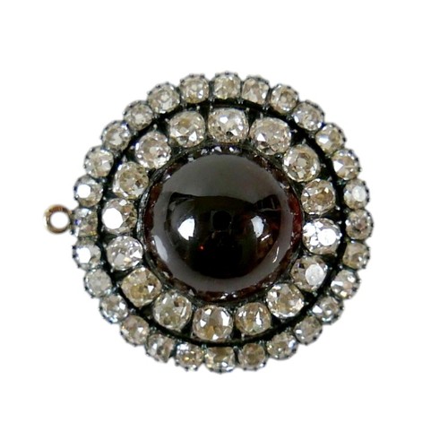 9 - A 19th century yellow metal diamond brooch with a central red paste cabochon 13mm diameter surrounde... 