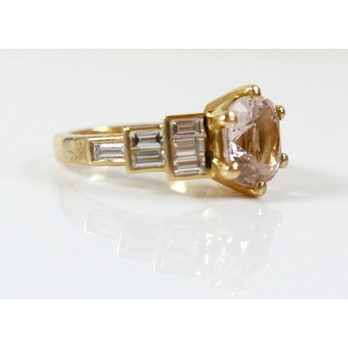 8 - A yellow gold Beryl Morganite and diamond ring set with a central cushion cut stone measuring approx... 