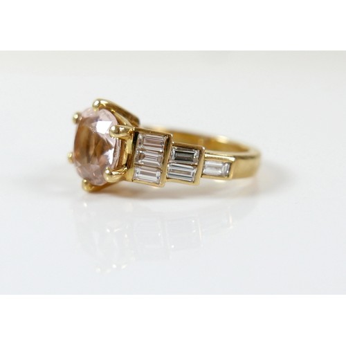 8 - A yellow gold Beryl Morganite and diamond ring set with a central cushion cut stone measuring approx... 