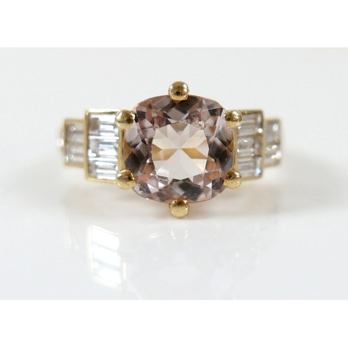 8 - A yellow gold Beryl Morganite and diamond ring set with a central cushion cut stone measuring approx... 