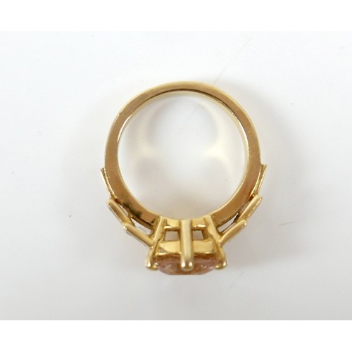 8 - A yellow gold Beryl Morganite and diamond ring set with a central cushion cut stone measuring approx... 