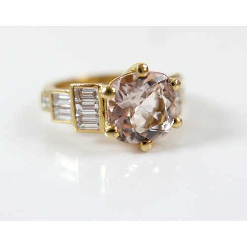 8 - A yellow gold Beryl Morganite and diamond ring set with a central cushion cut stone measuring approx... 