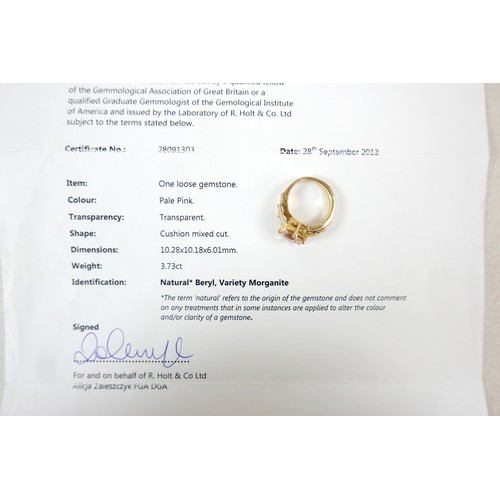 8 - A yellow gold Beryl Morganite and diamond ring set with a central cushion cut stone measuring approx... 