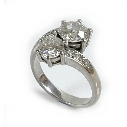 1 - An 18ct white gold and diamond crossover ring, 'Toi et Moi', made by Heidi Kjeldsen of Oakham using ... 