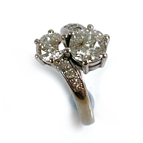 1 - An 18ct white gold and diamond crossover ring, 'Toi et Moi', made by Heidi Kjeldsen of Oakham using ... 
